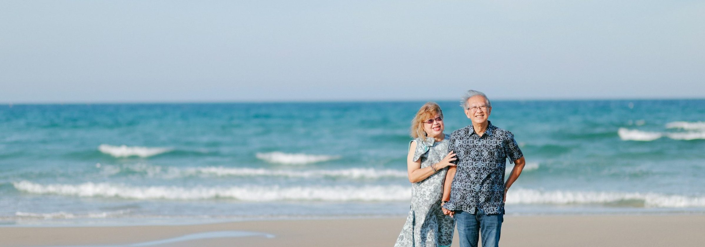 a couple posing happily by the Algarve sea